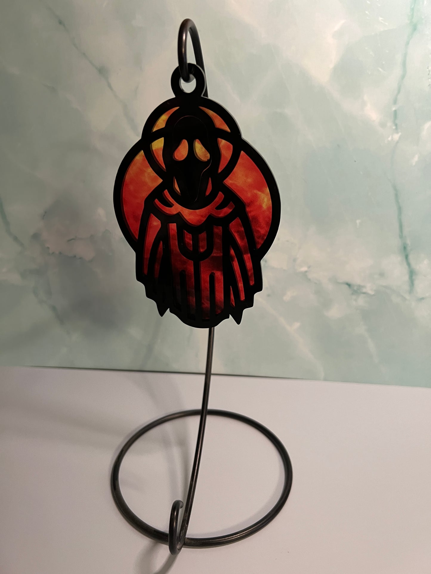 Acrylic Black Spooky Ghoul Suncatcher Ornament with red background