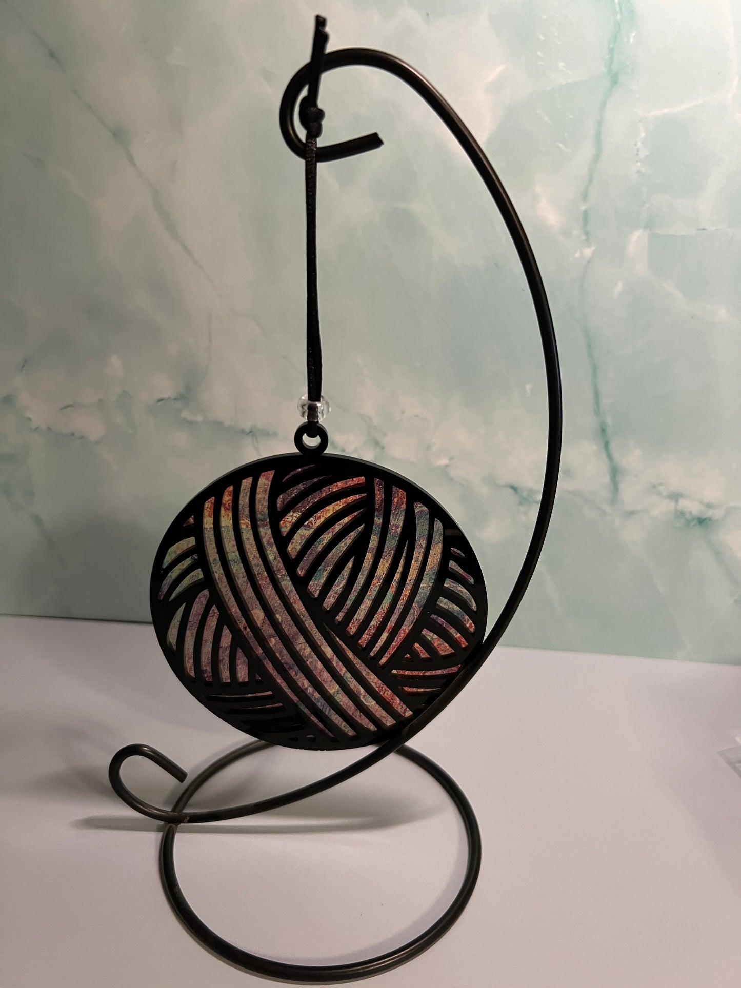 Acrylic Black Yarn Ball Suncatcher/Ornament with gold/brown background